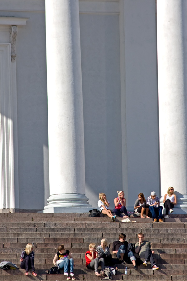 People enjoying a summer day at the steps of the Helsinki cathedral