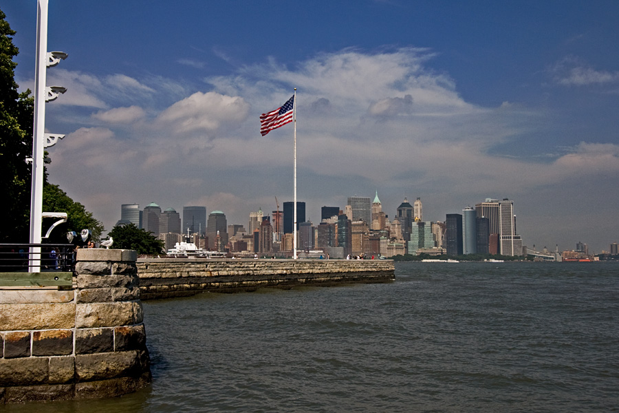 Stars and stripes on Ellis Island, Manhattan in the background