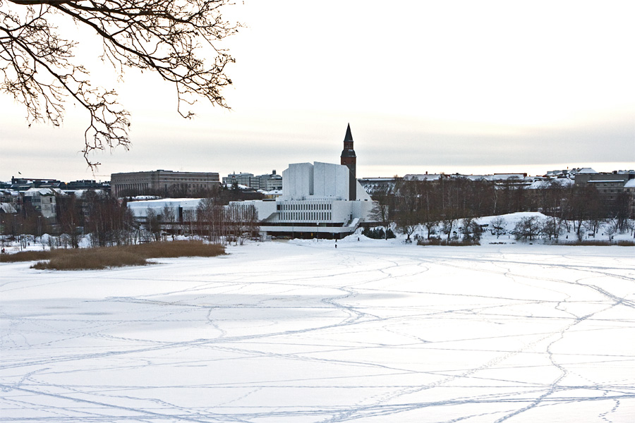 The tower of the national museum of Finland blends to the wall of Finlandia Hall