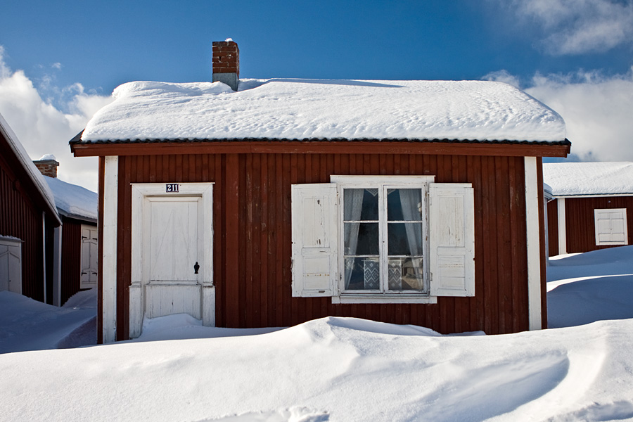 A cabin covered in snow